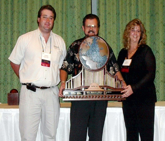 Lynn Arbuthnot and Jeremie Paulin are receiving the WMIA Partner of the Year Award from Mike Mendenhall, President of California Woodworking Machinery.
